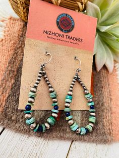 New without tags BRAND : Nizhoni Traders LLC JEWELRY TYPE : Earrings TYPE : Earrings STYLE : Dangle METAL : Sterling Silver MAIN STONE : Turquoise Lovely Handmade Turquoise, Lapis and Sterling Silver Beaded Dangle Hoop Earrings. Such beautiful craftsmanship! These measure 2 1/8 inches long and 1 inch wide. Stones are natural and will vary. Thank you for checking out my store. Please contact us with any questions. 4/25/23 Artisan Turquoise Drop Earrings Jewelry, Artisan Drop Earrings With Dangling Beads, Southwestern Jewelry With Dangling Beads For Gift, Artisan Teardrop Earrings With Dangling Beads, Artisan Turquoise Jewelry With Dangling Beads, Turquoise Teardrop Earrings For Jewelry Making, Southwestern Jewelry With Round Beads For Pierced Ears, Bohemian Teardrop Earrings With Natural Stones, Handmade Turquoise Teardrop Earrings In Southwestern Style