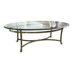 an oval glass table with metal legs