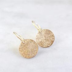 Raw Silk Textured Gold Disc Earrings Hammered Round Disc Earrings For Gift, Hammered Round Disc Earrings As Gift, Dainty Adjustable Gold Earrings, Hypoallergenic Round Earrings In Recycled Gold, Hypoallergenic Gold Brass Earrings, Gold Circular Earrings As Gift, Gold Circular Earrings For Gift, Gold Circle Earrings 14k Gold Filled, Gold Circle Earrings As Gift