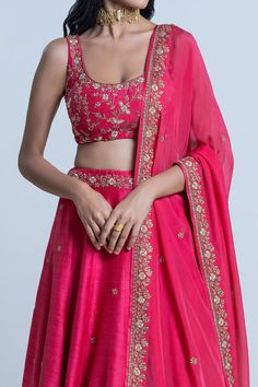 Pink raw silk floral embroidered lehenga with attached cancan. Paired with scoop neck padded blouse and dupatta.
Component: 3
Pattern: Embroidery
Type Of Work: Floral
Neckline: Scoop
Sleeve Type: Sleeveless
Fabric: Blouse and Lehenga: Raw Silk; Dupatta: Organza
Color: Pink
Other Details: 
Lehenga Length: 42 inches
Embroidered border dupatta
Tassel tie-up detailing
Note: The neckpiece worn by the model is not for sale
Occasion: Bride,Wedding - Aza Fashions Organza Embroidery, Pink Floral Blouse, Padded Blouse, Embroidered Lehenga, Embroidered Border, Embroidery Floral, Pattern Embroidery, Silk Dupatta, Floral Bridal