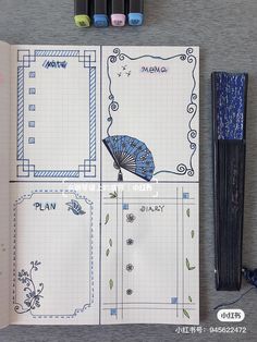 an open notebook with drawings and markers on the page next to it is a blue umbrella