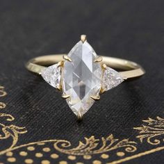 an engagement ring with three pear shaped diamonds