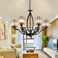 a living room filled with furniture and a large chandelier hanging from the ceiling