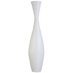 a tall white vase sitting on top of a table