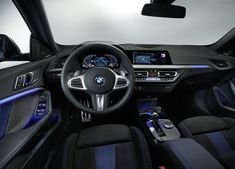 the interior of a modern car with blue lights