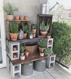 an outdoor plant stand with potted plants on it