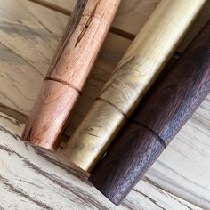 two wooden pens sitting on top of a table