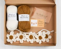 an open box with yarn and crochet items