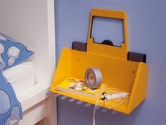 a yellow shelf that has a tape dispenser attached to it and a book on top