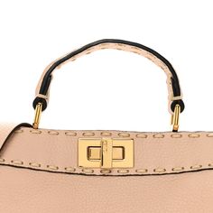 This is an authentic FENDI Cuoio Romano Selleria Chamois Small Peekaboo I SEE U Satchel in Rosa Plaster. This handmade tote is crafted of light pink grained calfskin leather with prominent hand stitching in off-white. The bag features a leather top handle, an optional shoulder strap, and a gold tone turn-lock on either side that opens the bag to a partitioned taupe microfiber interior with a patch pocket. Handmade Tote, Leather Top, Hand Stitching, Patch Pocket, Top Handle, Calf Skin, Light Pink, The Bag, Satchel