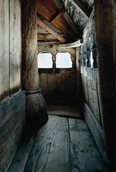 the inside of an old wooden cabin with two windows