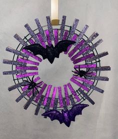 a purple wreath with bats hanging from it