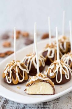 chocolate covered desserts on a white plate with caramel drizzle and nuts