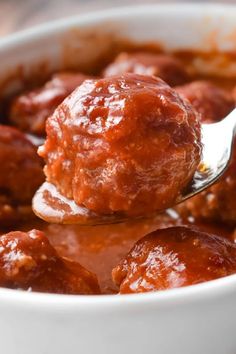 a spoon full of meatballs and sauce with the words, ham balls on it