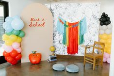 a room decorated with balloons and decorations for back to school