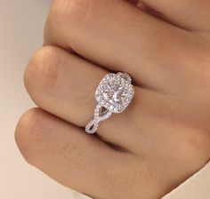 a woman's hand with a diamond ring on it