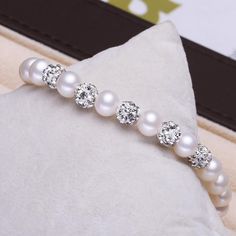 This beautiful Freshwater pearl bracelet ranges between 7-8mm in size and consists of beautiful and lustrous pearls in AAAA+ quality. All pearls in this bracelet are round and are strung with silk thread and double-knotted between each pearl. Known as the 'icon' of cultured pearls, Freshwater pearls have graced the necks, ears, fingers, and wrists of women for decades. Huge Tomato imports their Freshwater pearls from the Freshwater rs of Japan, grown in the Pinctada fucata oyster. All of our Fre Pearl White Round Beaded Bracelets, Pearl White Pearl Bracelet With 8mm Beads As Gift, Pearl Bracelet With 8mm Beads, Pearl White Beaded Bracelet With Pearl Chain, Round Pearl Bracelet With 8mm Beads, 8mm Round Pearl Bracelet, 8mm Pearl Beads Bracelet, Round Pearl Crystal Bracelet For Gift, Elegant Crystal Bracelet With 8mm Beads