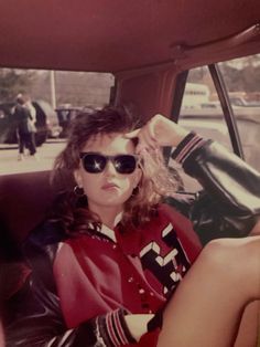 a woman sitting in the back seat of a car