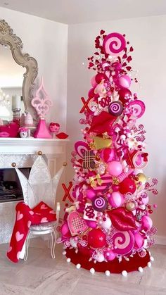 a pink christmas tree decorated with hearts and ornaments