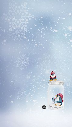 two penguins sitting on top of a glass jar with snowflakes in the background