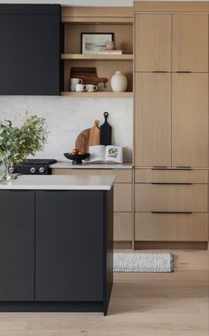 a kitchen with black cabinets and white counter tops