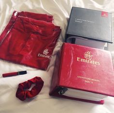 the contents of an emirates shirt and tie laid out on a bed