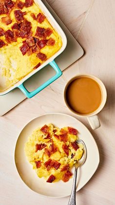 an omelet with bacon on top and a cup of coffee next to it