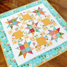 a quilted table topper on a wooden floor