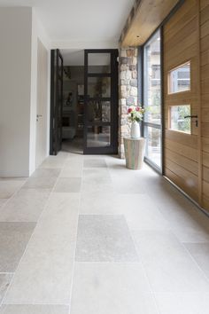 an empty hallway leading to a large glass door