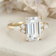 an emerald cut diamond ring with three side stones