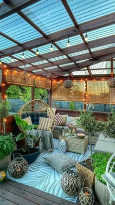 an outdoor patio with lots of plants and lights