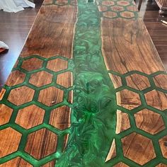 the table is made out of wood and has green paint on it's edges