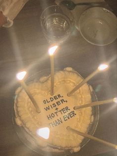 a cake with candles on it that says older wise, hotter, than ever