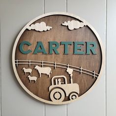 a wooden sign that says,'cartier with farm animals and tractor on it