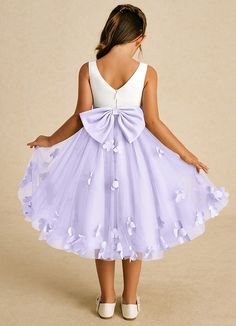 Sprout combines an enchanting A-line shape with a blend of tulle and matte satin. Its sweet scoop neckline and elegant V-back are complemented by a charming zipper closure and adorable bows, creating a delightful look for any little girl on a special occasion. This dress is not only perfect for a flower girl at a wedding but also versatile enough for other special occasions. Lilac Flower Girl Dresses, Purple Flower Girls, Tea Length Flower Girl Dress, Purple Flower Girl Dress, Purple Girls Dress, Tea Length Tulle, Flower Girl Dresses Blue, Cute Formal Dresses, Military Ball Dresses