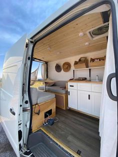 the interior of a camper van with its door open and storage area in place