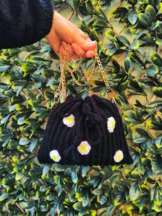 Handmade crochet black bag with white daisies flowers and with metal gold chain. Product size:  Width- 24 cm Length- 21 cm Chain -120 cm Color: black with white daisies flowers ( color discrepancies may occur due to different monitor settings). Material: acrylic yarn. Product care- machine washable, cool wash-30o, do not iron, do not tumble dry, do not chloride bleach, dry clean. Handmade Black Bags For Spring, Chic Black Crochet Bag For Spring, Black Shoulder Bag For Spring Gift, Sunflower Family, Crochet Black, Flowers Color, White Daisies, Black Bag, Acrylic Yarn