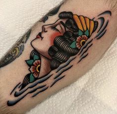 a woman's head with an abstract tattoo design on her leg