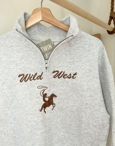 We sell primarily on our website and offer free shipping options. TwinRavenCo Giddy-up with these cozy Wild West quarter-zip sweaters. Fleece-lined, unisex, pre-shrunk, and are resistant to pilling- let's get to the point, these sweaters are durable and are sure to keep you comfy. Recommend to size-up if in-between sizes. * Check out our socials for discounts, new releases, and to see how we run our shop: TwinRavenCo We use the highest quality, sustainable thread on all of our products- check out our socials/website for more info.  *Everything in our shop is made-to-order, we cannot accept returns- but please don't hesitate to contact us if any questions or concerns!! *Embroidery stabilizer is applied to the back of every embroidered item and is never to be removed. This is there to keep t Country Tops For Women, Western Quarter Zip, Thrifted Western Outfits, Western Hippie Fashion, Western Fall Fashion, Giddy Up, Western Hoodies, Western Sweaters, Embroidery Stabilizer