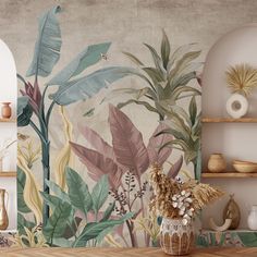 a wall mural with tropical leaves and plants on it in a living room or dining room