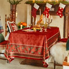 a christmas table setting with stockings and candles