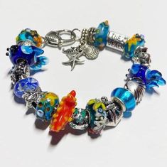 SAVE 35% WHEN YOU BUY 2 ITEMS AT THIS SHOP This hand-made, one-of-a-kind, Pandora compatible Murano glass bead hand-made bracelet would make a wonderful gift for yourself or someone special AND it comes in a gift box!  It's on a strong durable silver tone metal snake chain and consists of a combination of high-quality Murano glass lampwork, faceted, foil, and/or solid color glass, or artisan beads, and silver-tone metal rhinestone, crystal, flower, and/or decorative theme spacer beads.  NOTICE t Adjustable Glass Beaded Bracelets As Gift, Unique Beaded Bracelet With Spacer Beads As Gift, Glass Beads Gift, Czech Glass Bracelets With Large Beads As Gift, Glass Beaded Bracelets For Gifts, Charm Bracelet With Colorful Beads For Gift, Unique Czech Glass Beaded Bracelets As A Gift, Czech Glass Bracelets With Spacer Beads As Gift, Czech Glass Bracelets With Spacer Beads For Gifts