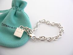 Overview: Here is a gift that she will surely adore! It is shiny, stylish, and super versatile! This piece will make someone REALLY happy! :) Offered for sale is a wonderful Tiffany & Co. Sterling Silver Signature Shopping Bag Charm Bracelet. Hanging from its bright Tiffany silver chain is a very pretty Shopping Bag charm with the words "Tiffany & Co" on it! A classic Tiffany piece that any girl will adore! Very pretty and just an adorable piece! It is simple, elegant, and classic all rolled int Tiffany And Co Bracelet, Tiffany And Co Jewelry, Professional Office, Knot Earrings, Tiffany And Co, Office Attire, Bracelet Bangle, Weekend Wear, Simple Elegant