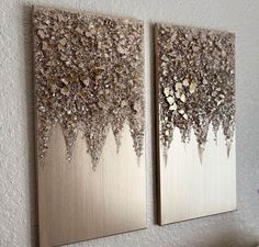 two metal wall art pieces hanging on the wall