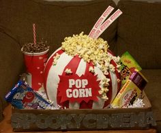 the popcorn bowl is filled with snacks and candy