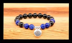 This beautiful charm bracelet is paired with the power duo of lapis lazuli, promoting inner peace and the shield of protection, black tourmaline. Choose a charm as a reminder to listen within for the truth. ✨ 100% Genuine stones, guaranteed. ✨ Hand selected beads with attention to detail. ✨ Bracelets are strung on high quality, latex free stretch cord. ✨ Always cleansed with sound and organic sage before packaging. ✨ Care instructions, clearing your crystals and intention setting cards are provided. ☮️Saging Karma© energy bracelets are individually created...After you have chosen each other.  Return to Saging Karma® shop: https://www.etsy.com/shop/SagingKarma?ref=seller-platform-mcnav © 2024 Saging Karma® Portland, Oregon.  All photographic images, jewelry and writing Copyright © Saging Ka Handmade Black Holistic Bracelets, Holistic Black Handmade Bracelets, Holistic Handmade Black Bracelets, Handmade Holistic Black Beaded Bracelets, Handmade Black Beaded Bracelets, Black Tourmaline Bracelet, Empath Protection, Intention Setting, Tourmaline Bracelet