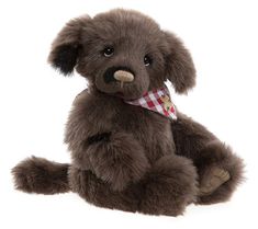 a brown teddy bear with a checkered bandanna around its neck