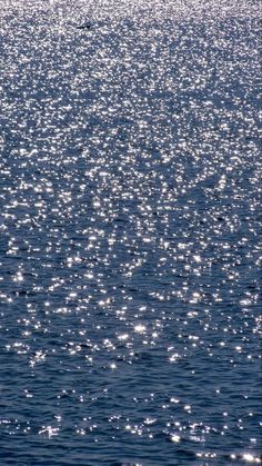 the sun shines on the water as it reflects off the ocean surface in this photo