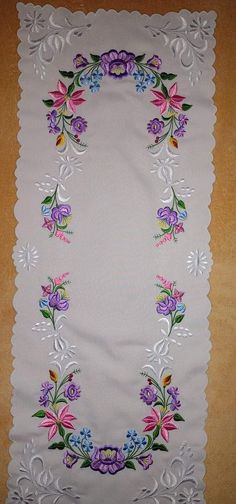 a white table cloth with colorful flowers on it