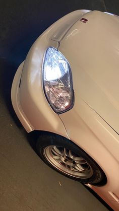 the front end of a white sports car